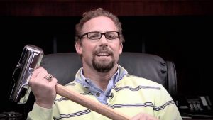 Pastor Clint Pressly holds a heavy mallet.