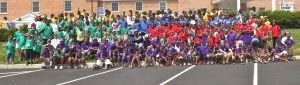 Group of People in various colored t-shirts from UP Wide.