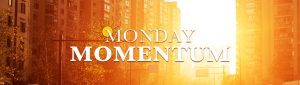 An orange and yellow glow over a city background with the words "Movement Monday" written across.