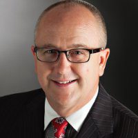 Three Charlotte PAtors Win Elite Wellness Package, White pastor headshot with glasses, black coat and red tie