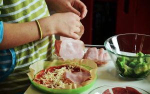105 Healthy Kid-Approved Lunch Ideas for this School Year, woman making a kids lucnh with green and white shirt on