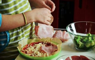 105 Healthy Kid-Approved Lunch Ideas for this School Year, woman making a kids lucnh with green and white shirt on
