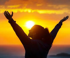 7 Bible Verses to Motivate You to Exercise, woman with her hands up and open to God with the sunrise in the background