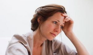 Is stress affecting your physical health, woman with teary eyes and light brown hair looking stressed out