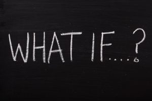 New Year's Resolutions from God - what if - a chalk board with the words "What if" written in white chalk on it
