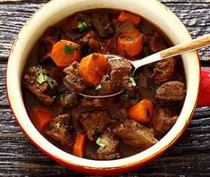 Foodie Friday - Beef Stew - a bowl full of beef stew, a spoon full someone is about to take