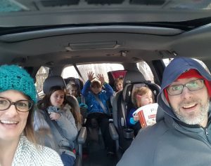 Meet Ministry Leader, Laura, Who's Goal is Longevity!, Laura and her husband Nic on a car ride with lots of kiddos