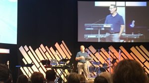 Kenny K. - A Shepherd Who Cares, Kenny preaching on Sunday with him on the screen behind him