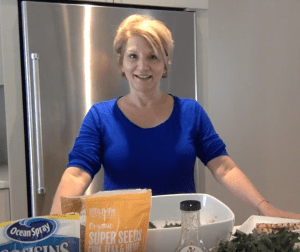 MissionFiT's Lunch Ladies - Episode 003 with Lady Zoe, headshot of Zoe in the kitchen getting ready to cook in a blue shirt