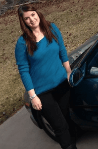 Testimony Tuesday with Rebekah Yandle, Rebekah smiling in a blue shirt in front of her car