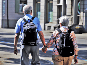 Keys to Better Health for Seniors, 2 elderly people walking with backpacks