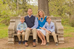 Testimony Tuesday with Emily Massey, Emily in a blue top with her family sitting on a bench