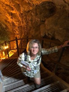 Sally climbing stairs in a cavern