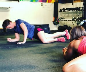 Female demonstrating mobility exercises for Pelvic Floor Function during Pelvic Floor Night, #1 of MissionFiT's Women's Health Series